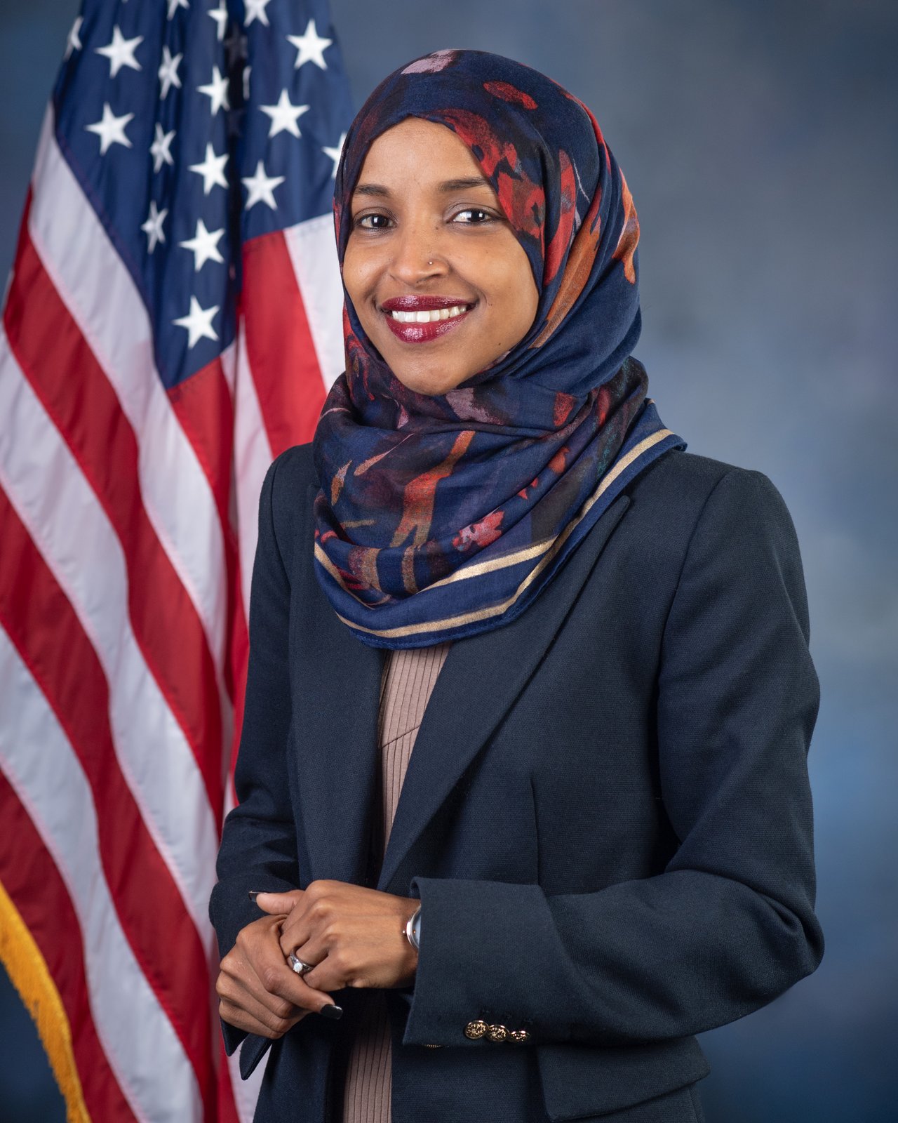 Rep. Ilhan Omar official portrait — spousal adjacency labeled; Mohd is the civil plaintiff.