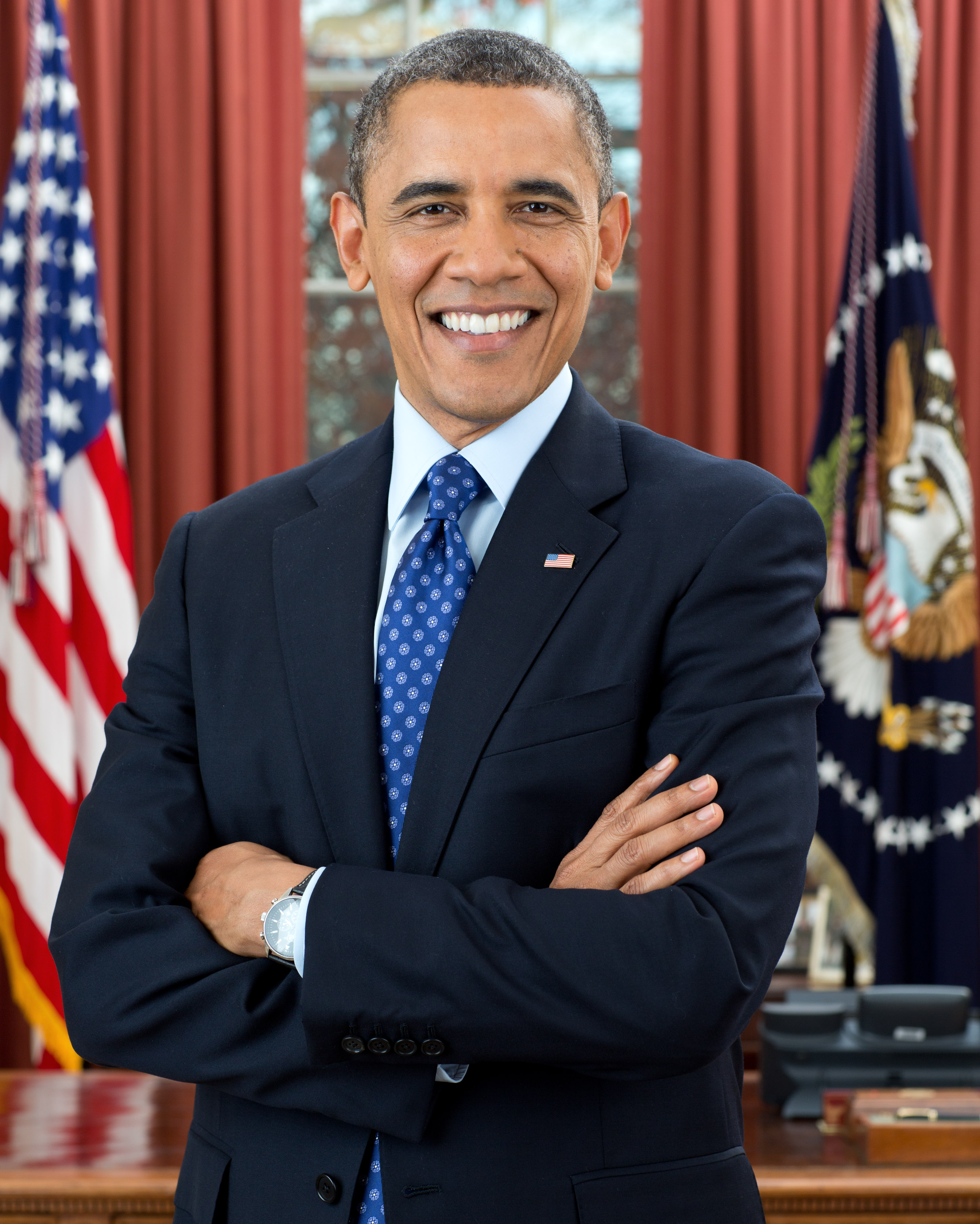 President Barack Obama standing in the Oval Office in his official 2012 portrait.